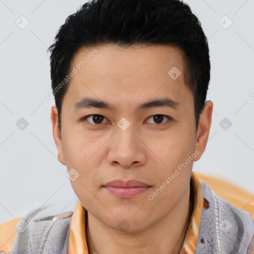 Joyful asian young-adult male with short  brown hair and brown eyes