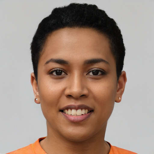 Joyful latino young-adult female with short  black hair and brown eyes