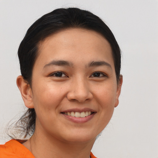 Joyful asian young-adult female with short  brown hair and brown eyes