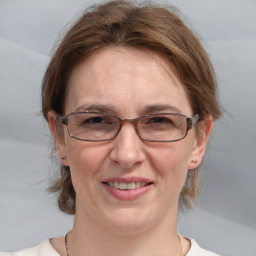 Joyful white adult female with medium  brown hair and brown eyes