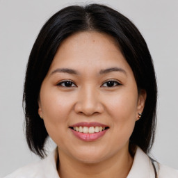 Joyful asian young-adult female with medium  brown hair and brown eyes