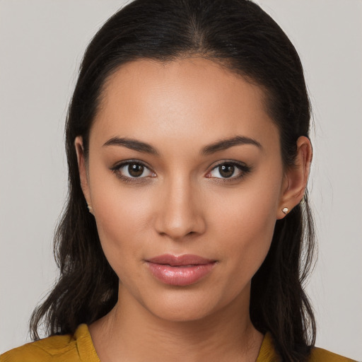 Joyful latino young-adult female with long  brown hair and brown eyes