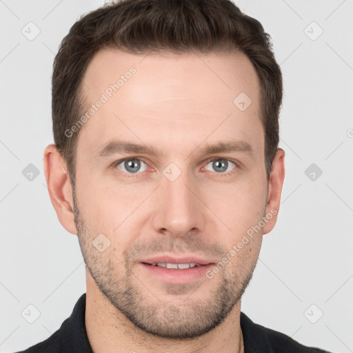 Joyful white young-adult male with short  brown hair and grey eyes