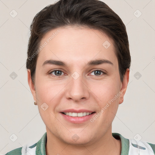 Joyful white young-adult female with short  brown hair and grey eyes