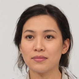 Joyful asian young-adult female with medium  brown hair and brown eyes