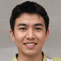 Joyful asian young-adult male with short  brown hair and brown eyes