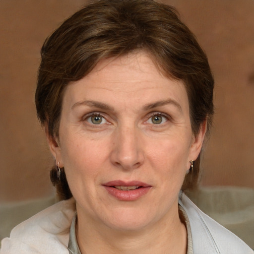 Joyful white adult female with medium  brown hair and grey eyes