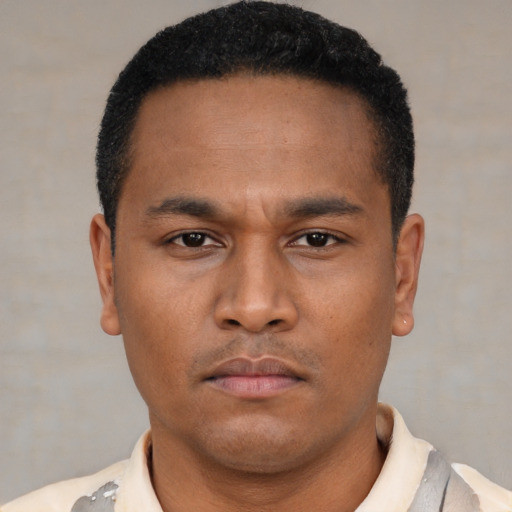 Neutral latino young-adult male with short  brown hair and brown eyes