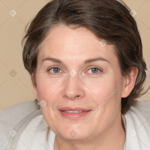 Joyful white adult female with medium  brown hair and blue eyes