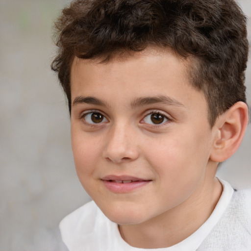 Joyful white child male with short  brown hair and brown eyes