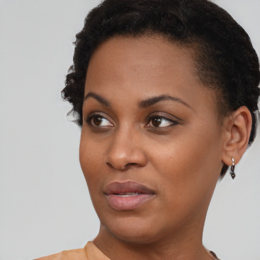 Joyful black young-adult female with short  brown hair and brown eyes