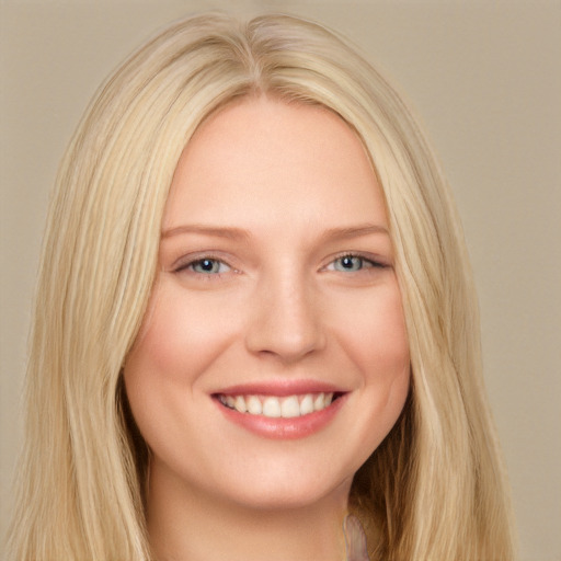 Joyful white young-adult female with long  blond hair and blue eyes