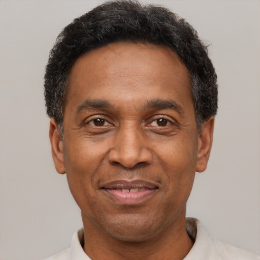 Joyful latino adult male with short  black hair and brown eyes