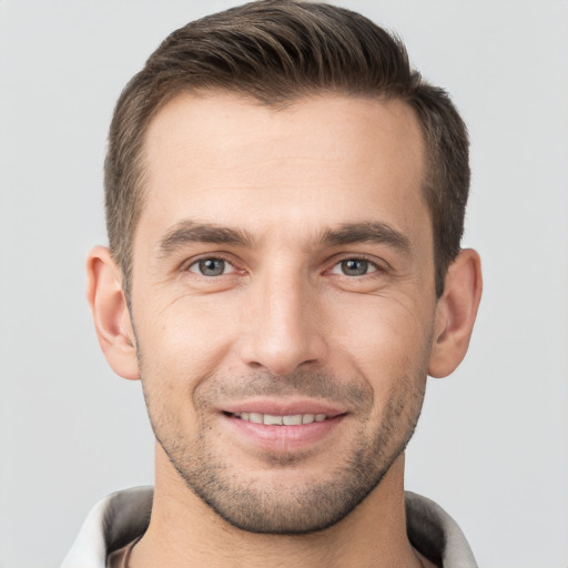 Joyful white young-adult male with short  brown hair and brown eyes