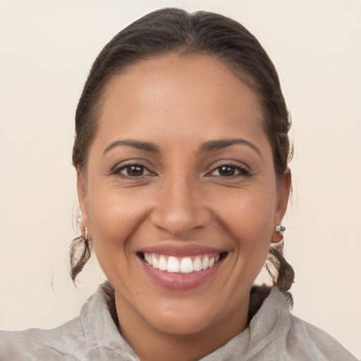 Joyful latino young-adult female with medium  brown hair and brown eyes