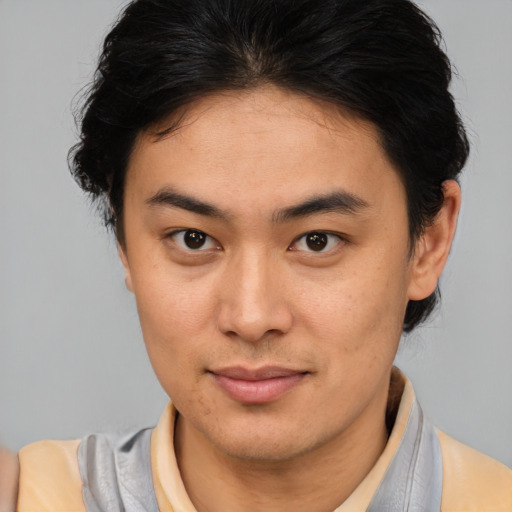 Joyful latino young-adult male with medium  brown hair and brown eyes