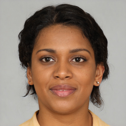 Joyful black young-adult female with medium  brown hair and brown eyes