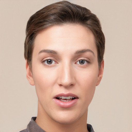 Joyful white young-adult female with short  brown hair and grey eyes