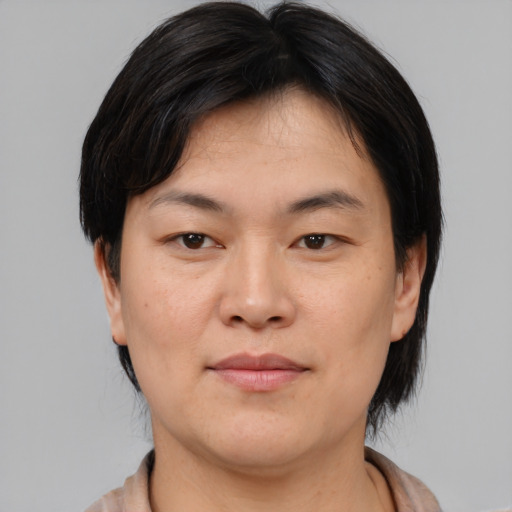 Joyful asian young-adult female with medium  brown hair and brown eyes