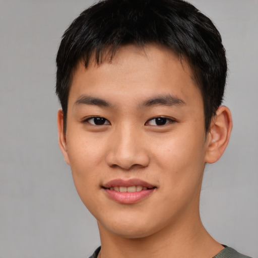 Joyful asian young-adult male with short  black hair and brown eyes