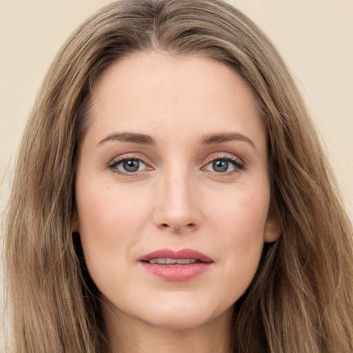 Joyful white young-adult female with long  brown hair and green eyes