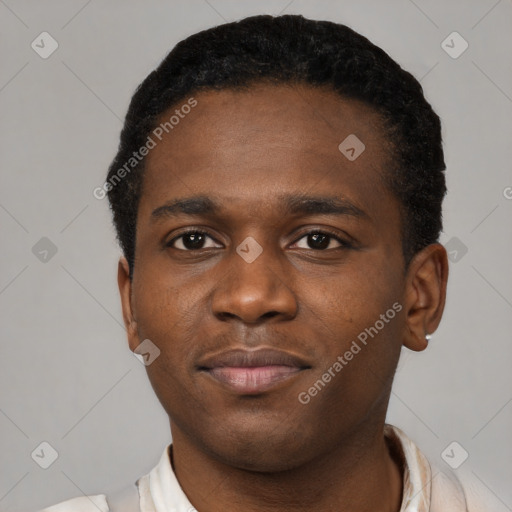 Joyful black young-adult male with short  brown hair and brown eyes