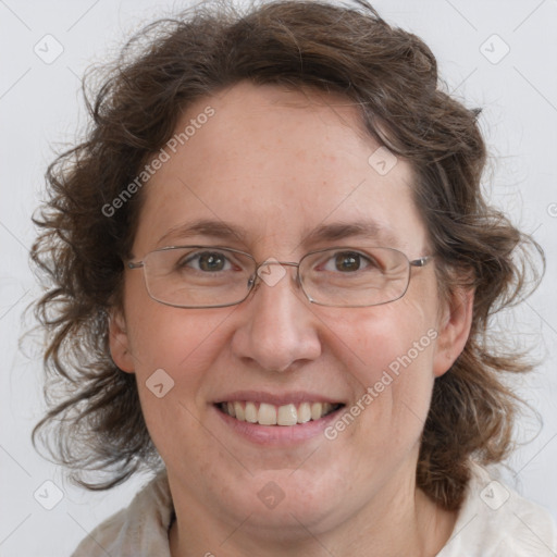 Joyful white adult female with medium  brown hair and blue eyes