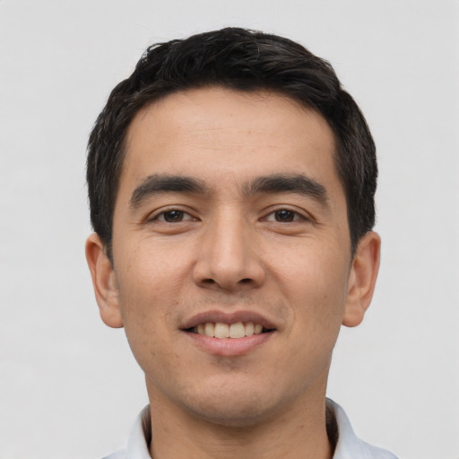Joyful white young-adult male with short  black hair and brown eyes