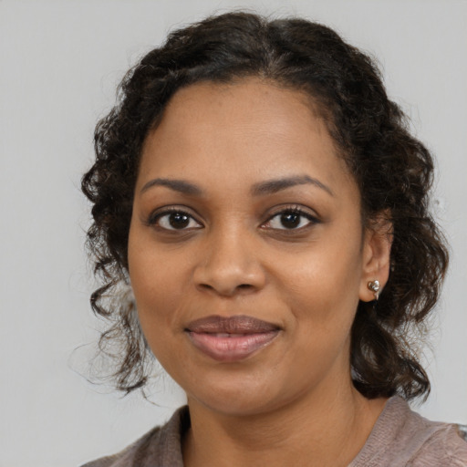 Joyful black young-adult female with medium  brown hair and brown eyes