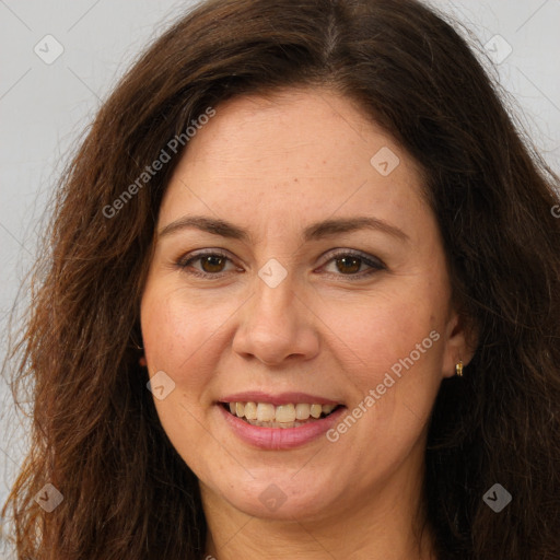 Joyful white adult female with long  brown hair and brown eyes