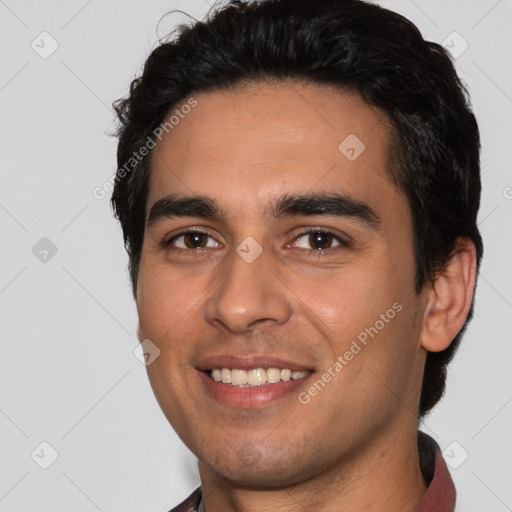 Joyful white young-adult male with short  black hair and brown eyes