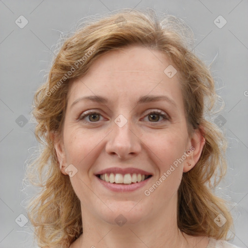 Joyful white young-adult female with medium  brown hair and blue eyes