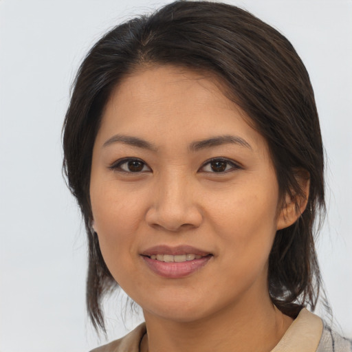 Joyful asian young-adult female with medium  brown hair and brown eyes