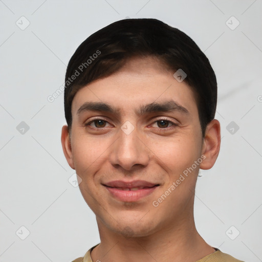 Joyful white young-adult male with short  black hair and brown eyes