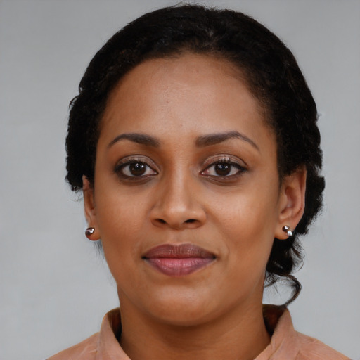 Joyful black young-adult female with medium  black hair and brown eyes