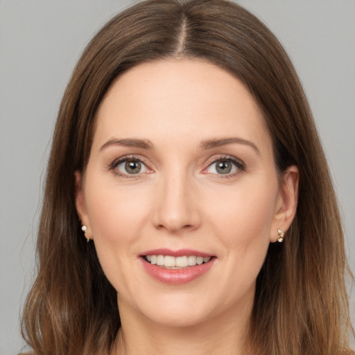 Joyful white young-adult female with long  brown hair and brown eyes