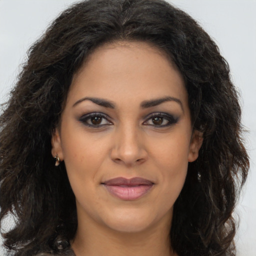 Joyful latino young-adult female with long  brown hair and brown eyes