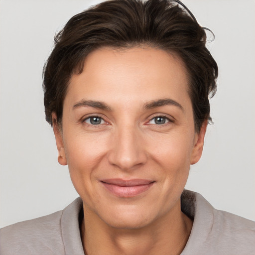 Joyful white adult female with short  brown hair and grey eyes