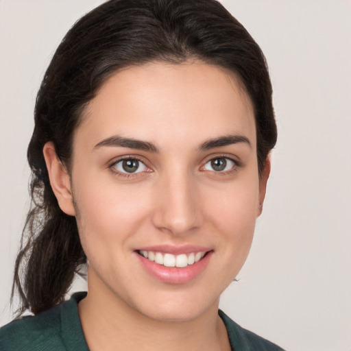 Joyful white young-adult female with medium  brown hair and brown eyes