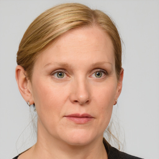 Joyful white adult female with medium  brown hair and blue eyes