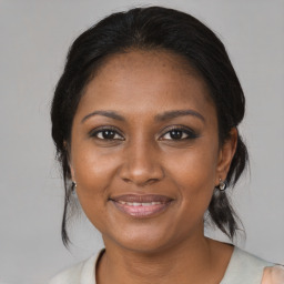 Joyful black adult female with medium  brown hair and brown eyes