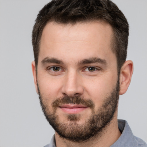 Joyful white young-adult male with short  brown hair and brown eyes