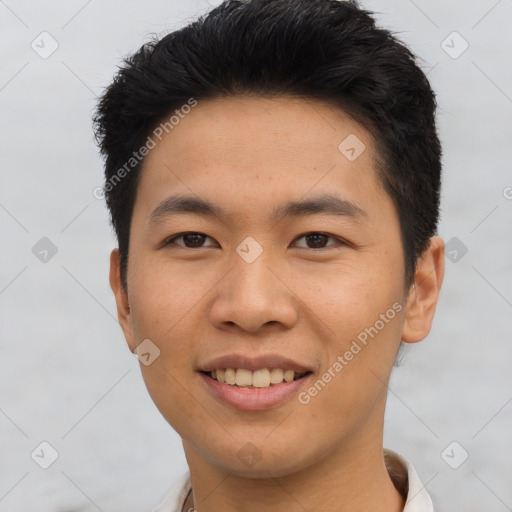 Joyful asian young-adult male with short  black hair and brown eyes