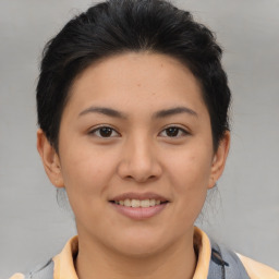 Joyful asian young-adult female with short  brown hair and brown eyes