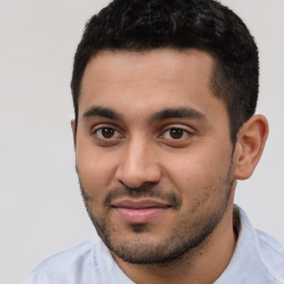 Joyful latino young-adult male with short  black hair and brown eyes