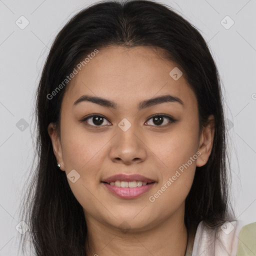 Joyful latino young-adult female with long  brown hair and brown eyes