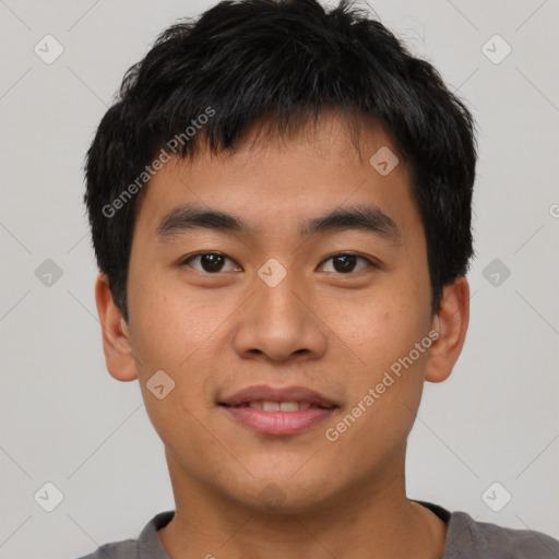 Joyful asian young-adult male with short  black hair and brown eyes