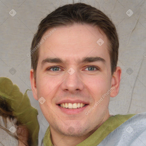 Joyful white young-adult male with short  brown hair and grey eyes