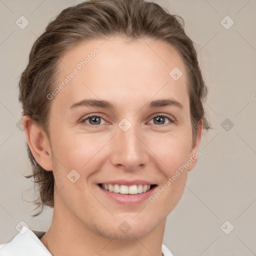 Joyful white young-adult female with short  brown hair and grey eyes