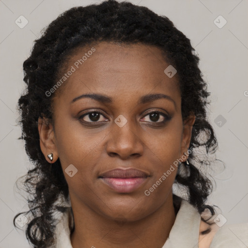 Joyful black young-adult female with long  brown hair and brown eyes